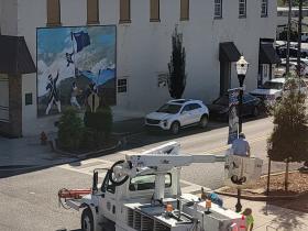 Street Department hang Veterans Day banners