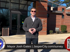 Mayor Gates in front of Memorial Park Natatorium