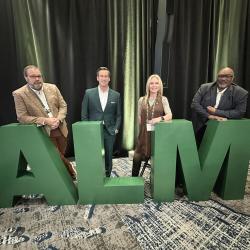 Councilmember Moody, Mayor Gates, Councilmember Smith, Councilmember Moore standing behind large A L M letters