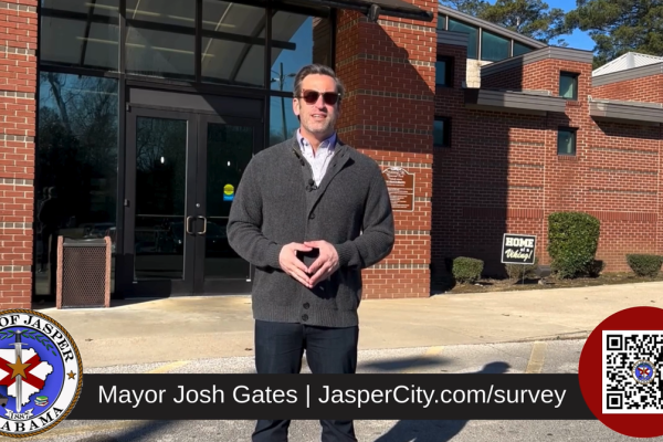 Mayor Gates in front of Memorial Park Natatorium
